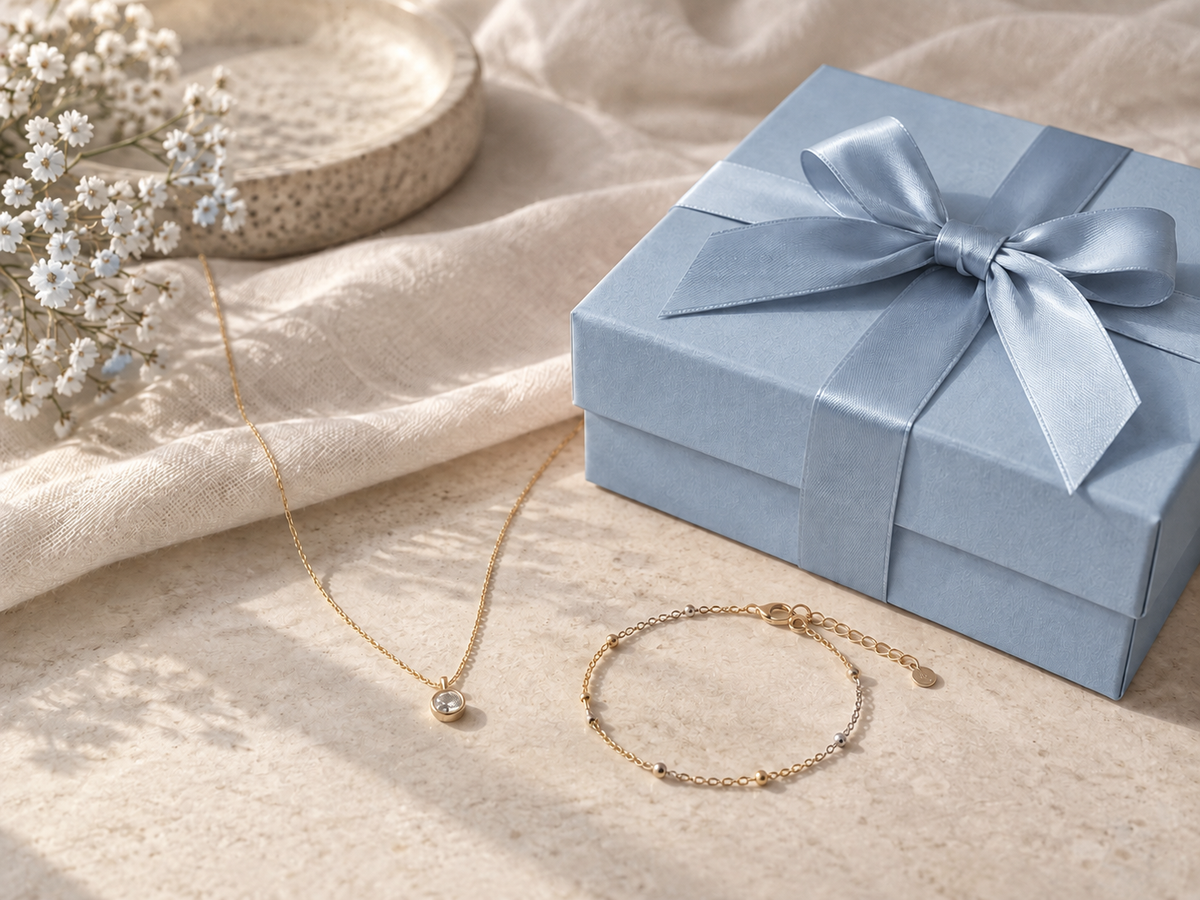 Illustrative photograph of a powder-blue gift box beside delicate jewelry